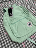 Light green backpack with Converse logo on a checkered background