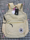 Beige backpack with Converse logo on a checkered background