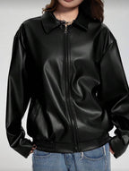 Person wearing a black leather jacket on a plain background