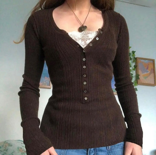 Brown ribbed sweater worn by a person with a neutral background