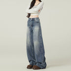 Person wearing wide-leg jeans and a white crop top on a plain background