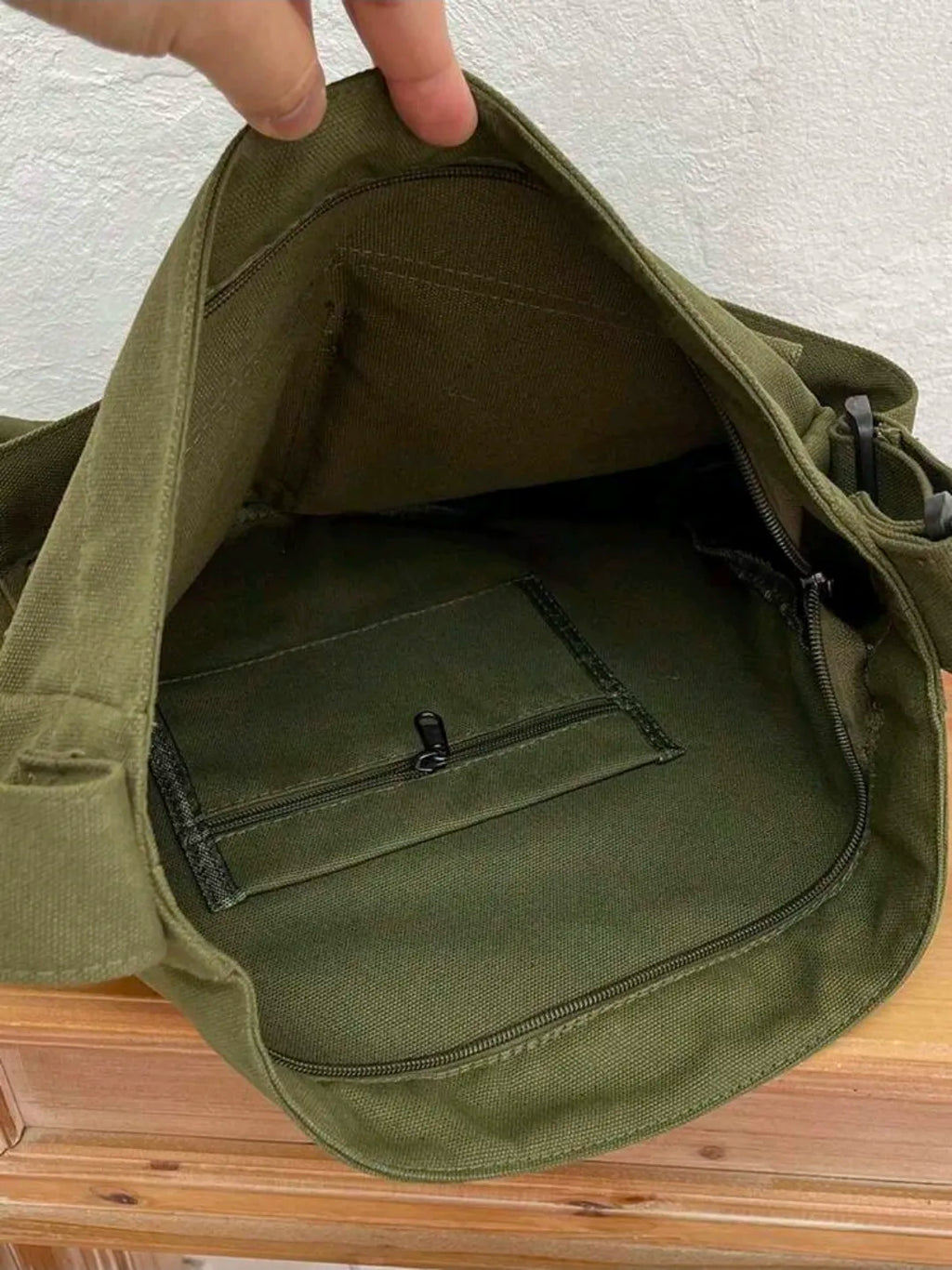 Green bag with a pocket on a wooden surface