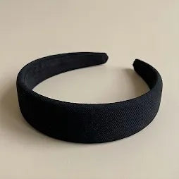 Black headband on a beige background