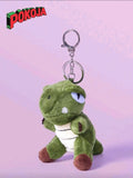 Green plush keychain with a dinosaur design on a pink background, featuring the Pokoja brand.