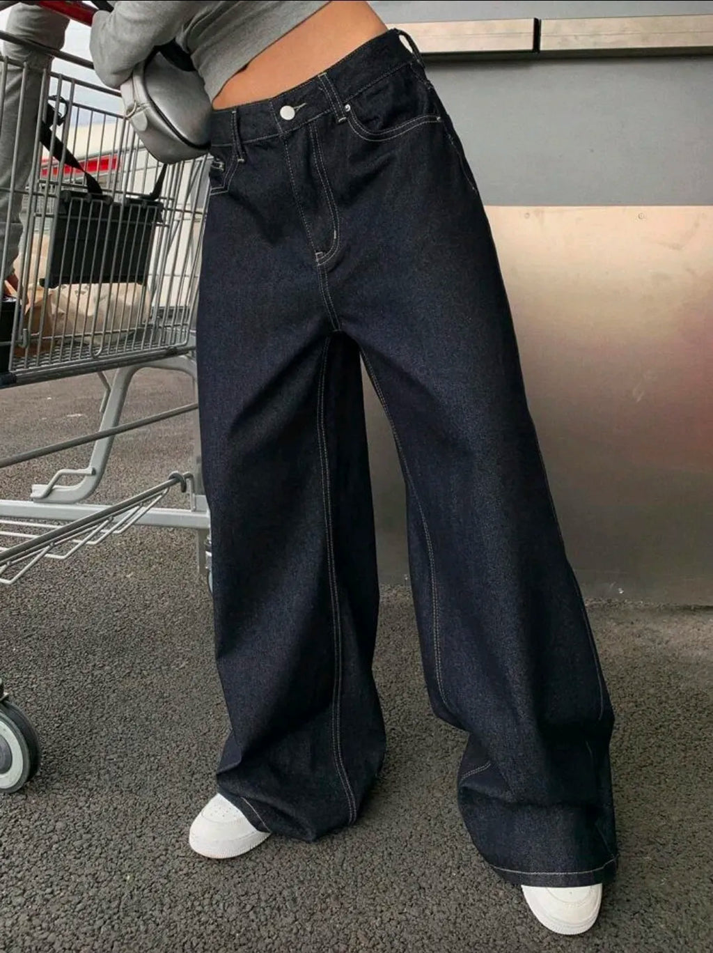 Person wearing wide-leg jeans in an urban setting
